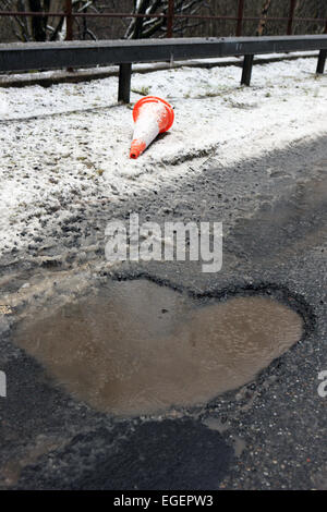 Deep potholes on Scotland's roads Stock Photo