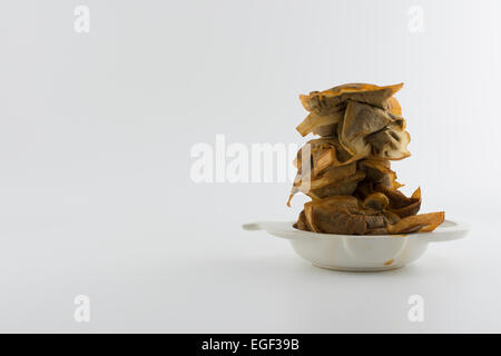 Procrastination - stack of used tea bags in stained tea bag holder Stock Photo