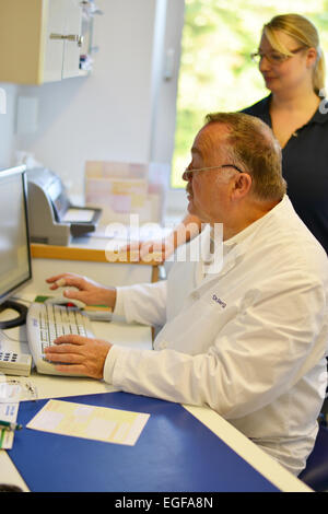 The family doctor – here in his surgery – fulfils an important task in the health system, whether during consultation or home vi Stock Photo