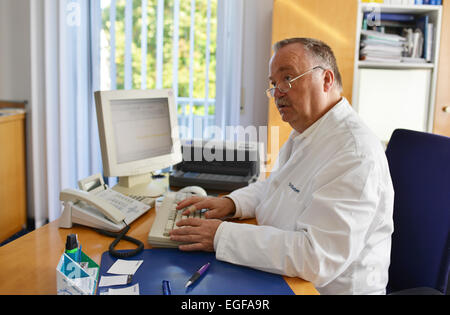 The family doctor – here in his surgery – fulfils an important task in the health system, whether during consultation or home vi Stock Photo