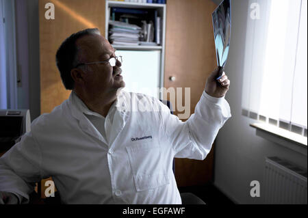 The family doctor – here in his surgery – fulfils an important task in the health system, whether during consultation or home vi Stock Photo