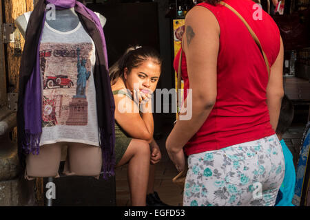 Shopkeeper in Oaxaca, Mexico is watching the street for customers Stock Photo
