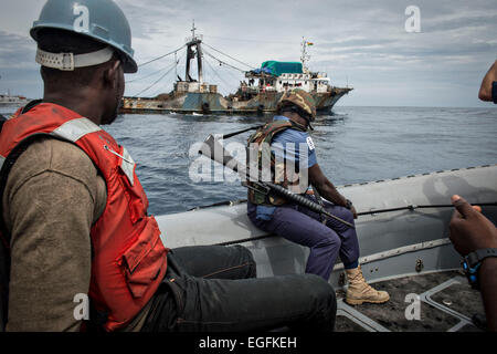 Ghanian Navy sailors approach a fishing vessel during a visit, board, search, and seizure of a fishing vessel with member of the U.S. Navy as part of Africa Maritime Law Enforcement Partnership February 19, 2015 off the coast of Ghana. Stock Photo