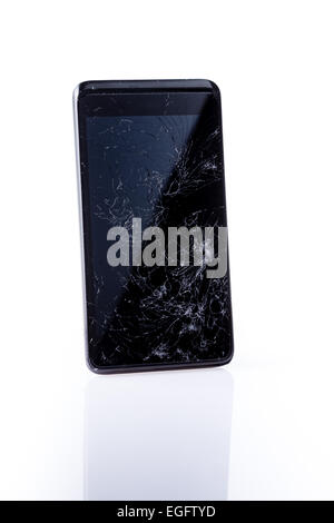 Closeup of mobile smartphone with broken screen, on white with reflection Stock Photo