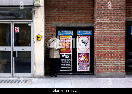 Man in central London checking his mobile phone Stock Photo