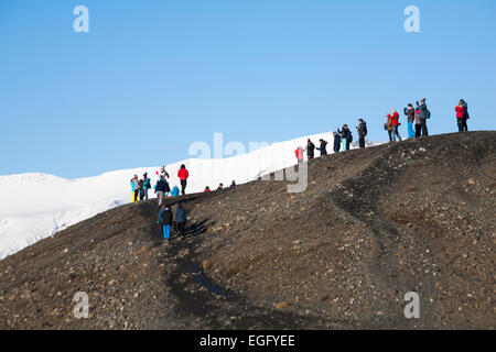 People stood looking down to admire the views and take photos at Jokulsarlon Glacial Lagoon, on the edge of Vatnajokull National Park, Iceland in Feb Stock Photo
