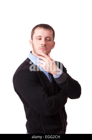 Attractive man thoughtfully rubbing his chin Stock Photo