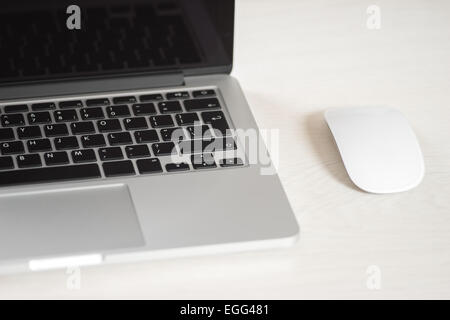 Laptop on a light table with a mouse Stock Photo