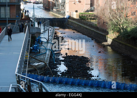 Birmingham, West Midlands, UK. 24th February, 2015. A 200m stretch of the Worcestershire and Birmingham Canal near to Gas Street Basin remains drained as engineers work to repair a leakage. The Canal and River Trust rescued hundreds of fish from the section before work began to find and repair the leak. Credit:  Colin Underhill/Alamy Live News Stock Photo