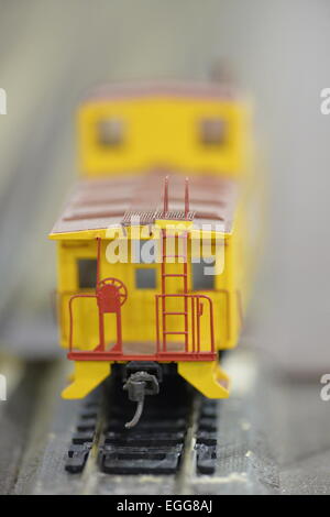 Hicksville, New York, USA. 22nd February 2015. A Union Pacific yellow caboose model train car travels on the track at the Model Train Exhibit ihsted by Trainville Hobby Depot at the Broadway Mall. Donations were accepted at exhibit to support the Nassau County Empire State Games for the Physically Challenged. Credit:  Ann E Parry/Alamy Live News Stock Photo