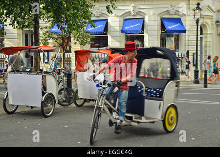 Man riding Rickshaw in London Street Stock Photo