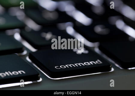 Illuminated Apple Macbook Pro keyboard command key - USA Stock Photo