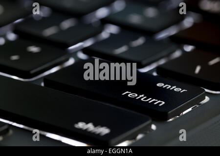 Illuminated Apple Macbook Pro keyboard return key - USA Stock Photo
