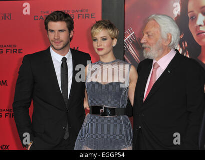 LOS ANGELES, CA - NOVEMBER 18, 2013: Jennifer Lawrence with Liam Hemsworth (left) & Donald Sutherland at the US premiere of their movie 'The Hunger Games: Catching Fire' at the Nokia Theatre LA Live. Stock Photo