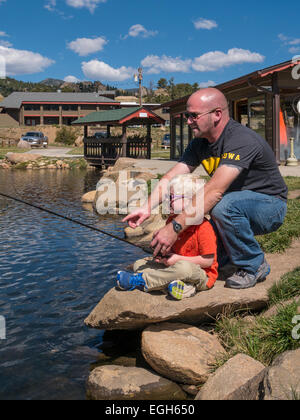 Father and son fish the pond at Trout Haven, Estes Park, Colorado. Stock Photo