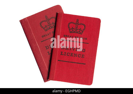 A pair of old style red cloth covered British driving licences. Stock Photo