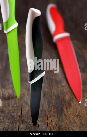 ceramic knifes on old wooden table Stock Photo