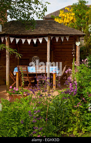 Wooden Outdoor Summerhouse in English Garden Stock Photo