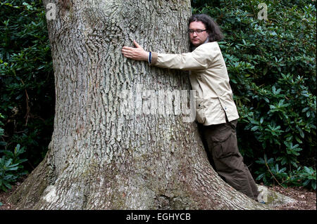 Man hugs big tree england Stock Photo