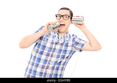 Silly man talking to himself through tin can phone isolated on white background Stock Photo