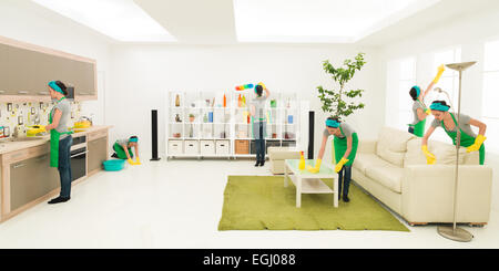 young caucasian woman cleaning home in different places at the same time Stock Photo