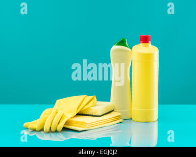 group of yellow cleaning tools on table with blue background Stock Photo