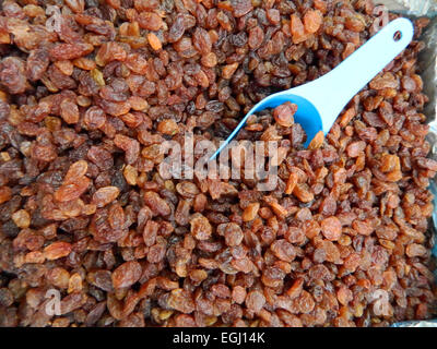 A larger quantity of sweet and tasty raisins on market stall waiting for customers. Stock Photo