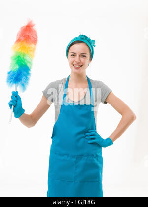 happy cleaning woman holding colorful synthetic feather duster, on white background Stock Photo