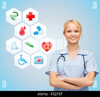 smiling doctor over medical icons blue background Stock Photo