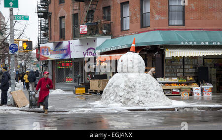 Large snowman built on the corner of Essex and Canal Streets on the lower east side in Manhattan, NYC. Stock Photo