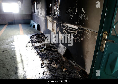 Feb. 25, 2015 - Bethlehem, West Bank, Palestinian Territory - Burnt Mosque is seen in the West Bank village of Jab'a, near Bethlehem, just south of Jerusalem, in an apparent attack by Jewish settlers overnight on 25 February 2015. Hate graffiti was spray painted on the building including a Star of David it what authorities believe is a 'price tag ' act of vandalism. The head of Jab'a village council Numan Hamdan said residents detected the fire and were able to put it out before it spread to the rest of the mosque, the Palestinian news agency WAFA reported. Damage was caused to the door and pa Stock Photo