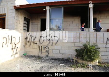 Feb. 25, 2015 - Bethlehem, West Bank, Palestinian Territory - Palestinians inspect the burnt mosque in the West Bank village of Jab'a, near Bethlehem, just south of Jerusalem, in an apparent attack by Jewish settlers overnight on 25 February 2015. Hate graffiti was spray painted on the building including a Star of David it what authorities believe is a 'price tag ' act of vandalism. The head of Jab'a village council Numan Hamdan said residents detected the fire and were able to put it out before it spread to the rest of the mosque, the Palestinian news agency WAFA reported. Damage was caused t Stock Photo