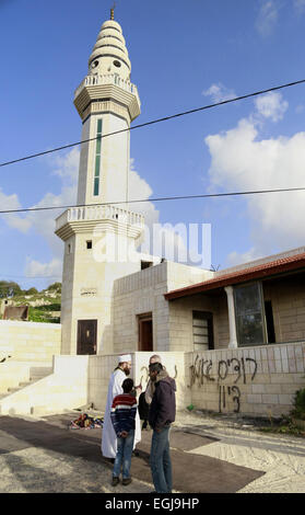 Feb. 25, 2015 - Bethlehem, West Bank, Palestinian Territory - Palestinians inspect the burnt mosque in the West Bank village of Jab'a, near Bethlehem, just south of Jerusalem, in an apparent attack by Jewish settlers overnight on 25 February 2015. Hate graffiti was spray painted on the building including a Star of David it what authorities believe is a 'price tag ' act of vandalism. The head of Jab'a village council Numan Hamdan said residents detected the fire and were able to put it out before it spread to the rest of the mosque, the Palestinian news agency WAFA reported. Damage was caused t Stock Photo