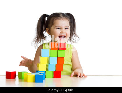 Beautiful kid building a castle with cubes Stock Photo