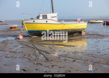 Inshore fishing boats in Morecambe Bay, aground and waiting for the next tide Stock Photo