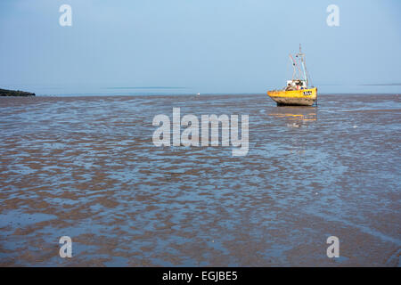 Inshore fishing boats in Morecambe Bay, aground and waiting for the next tide Stock Photo