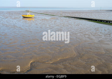 Inshore fishing boats in Morecambe Bay, aground and waiting for the next tide Stock Photo