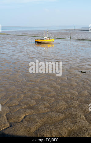 Inshore fishing boats in Morecambe Bay, aground and waiting for the next tide Stock Photo