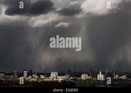 Dark storm clouds, heavy rain with sun break moves across central London Stock Photo