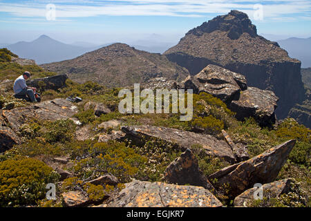 Hiker approaching Mt Anne, the highest peak in south west Tasmania Stock Photo