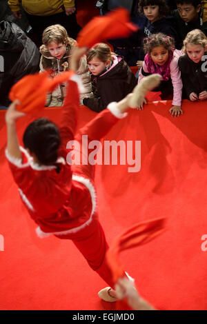 Berlin, Germany. 25th Feb, 2015. Children view a Chinese dancer performing to celebrate the Chinese traditional lunar New Year, or Spring Festival at Berlin's Arkaden shopping mall in Potsdam Square, Berlin, Germany, on Feb. 25, 2015. © Zhang Fan/Xinhua/Alamy Live News Stock Photo