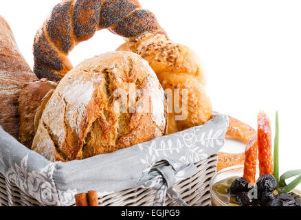Various types of bread roll and bun in a basket, studio shot on white background Stock Photo