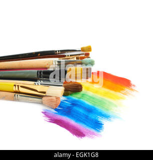 Pile of different brushes over the paint strokes Stock Photo