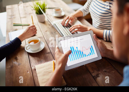 Businessperson studying electronic data in digital tablet Stock Photo