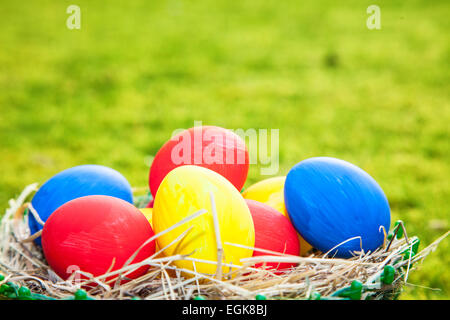 Colorful easter eggs lying in basket Stock Photo