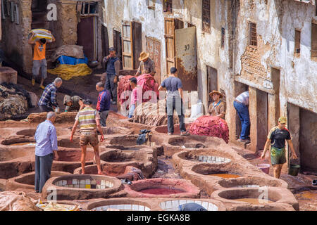 Local people painting leather at a tannery in Fez, Morocco Stock Photo