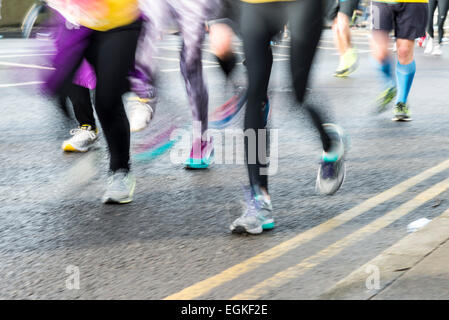 Blurred legs and feet of marathon runners.  Motion blur athletes running. Stock Photo