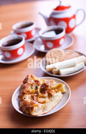 two pieces of apple pie on a front and three cups of tea on background Stock Photo