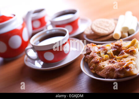 two pieces of apple pie on a front and three cups of tea on background Stock Photo