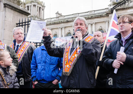 16th February 2013, Belfast, Northern Ireland.  Sam McCrory, a member of the Orange Order and the Protestant Coalition reads a section from the Sinn Fein manifesto to the crowds of protesters at Belfast City Hall Stock Photo